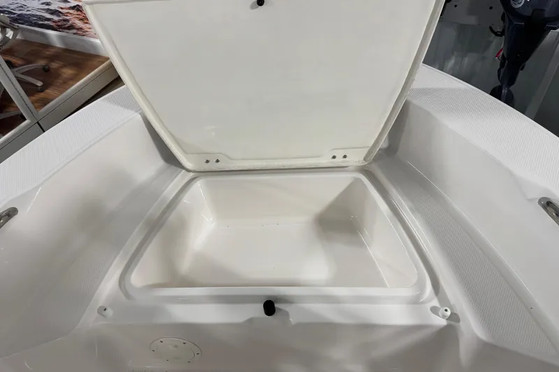 Slide: The Image of 2026 Robalo R160 Center Console boat storage compartment open. - 10