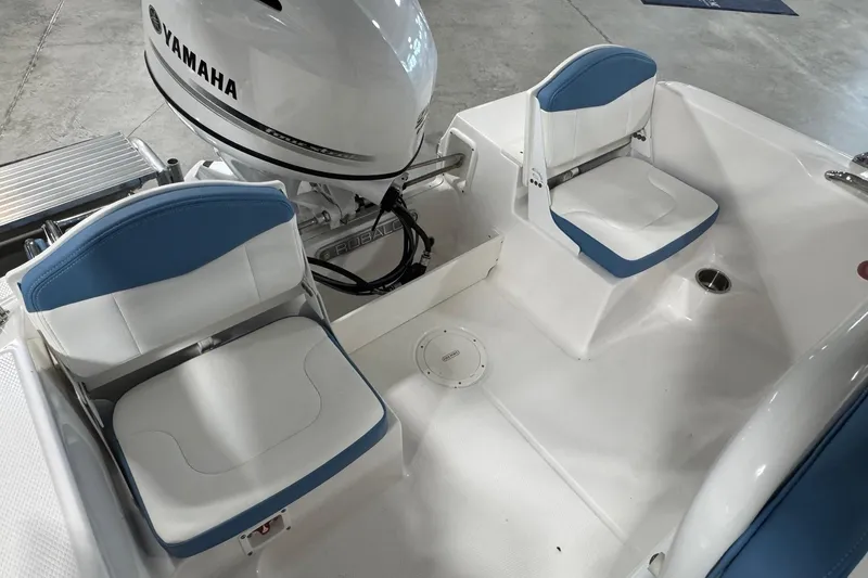 Slide: The Image of 2026 Robalo R160 Center Console boat interior with Yamaha engine and cushioned seating. - 14