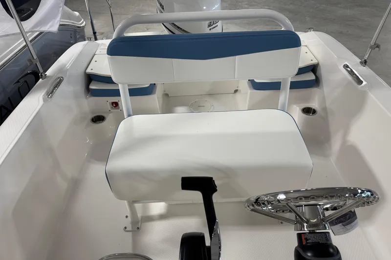 Slide: The Image of 2026 Robalo R160 Center Console boat interior with steering wheel and seating. - 6