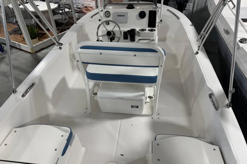 Slide: The Image of 2026 Robalo R160 Center Console boat interior with steering wheel and seating. - 7