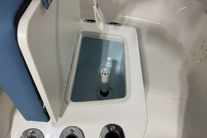 Slide: The Image of 2026 Robalo R160 Center Console livewell interior with open lid. - 8
