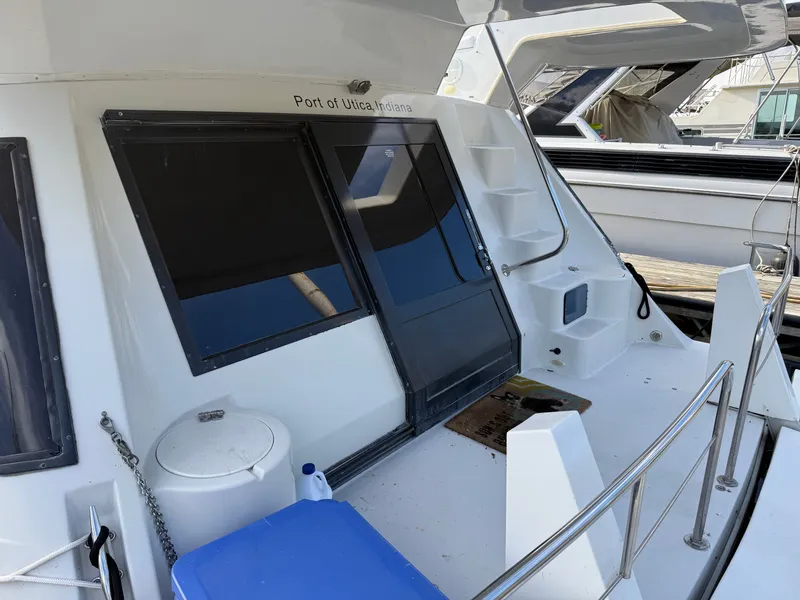 Slide: The Image of 1996 Bluewater Yachts 643 Motor Yacht docked, featuring sleek design and spacious deck area. - 13