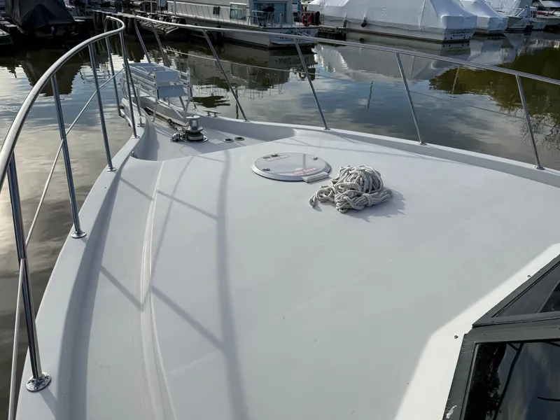 Slide: The Image of 1996 Bluewater Yachts 643 Motor Yacht deck with railing and coiled rope. - 14