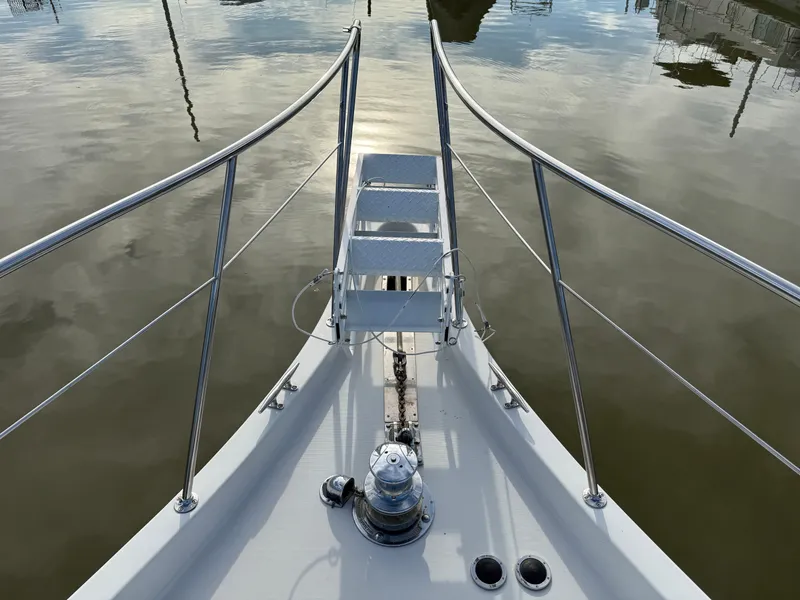 Slide: The Image of Bow view of 1996 Bluewater Yachts 643 Motor Yacht on calm water. - 15