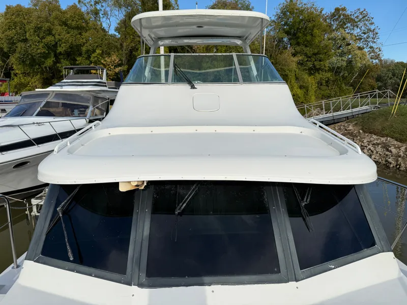 Slide: The Image of 1996 Bluewater Yachts 643 Motor Yacht docked, featuring sleek design and spacious deck. - 16