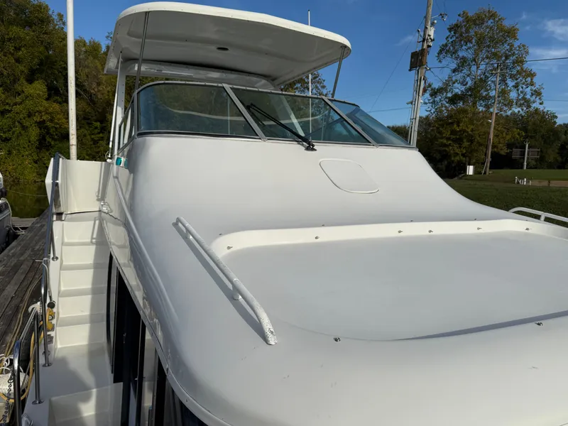 Slide: The Image of 1996 Bluewater Yachts 643 Motor Yacht with sleek white deck and covered helm. - 17