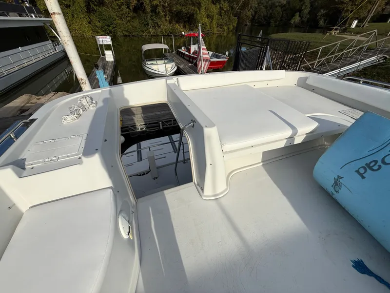 Slide: The Image of 1996 Bluewater Yachts 643 Motor Yacht deck with seating and dock view. - 19