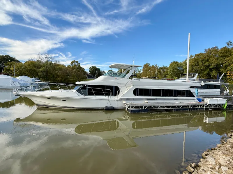 Slide: The Image of 1996 Bluewater Yachts 643 Motor Yacht docked on calm water under a clear sky. - 2