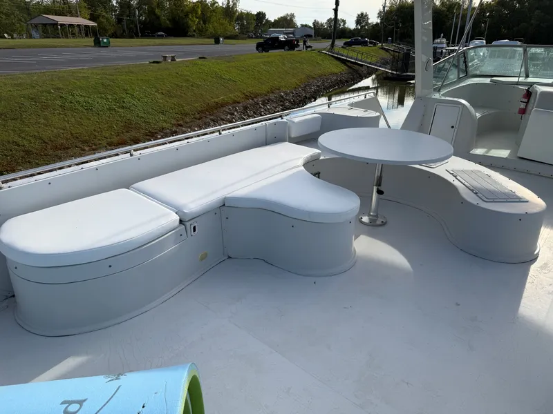Slide: The Image of 1996 Bluewater Yachts 643 Motor Yacht deck with white seating and table. - 21
