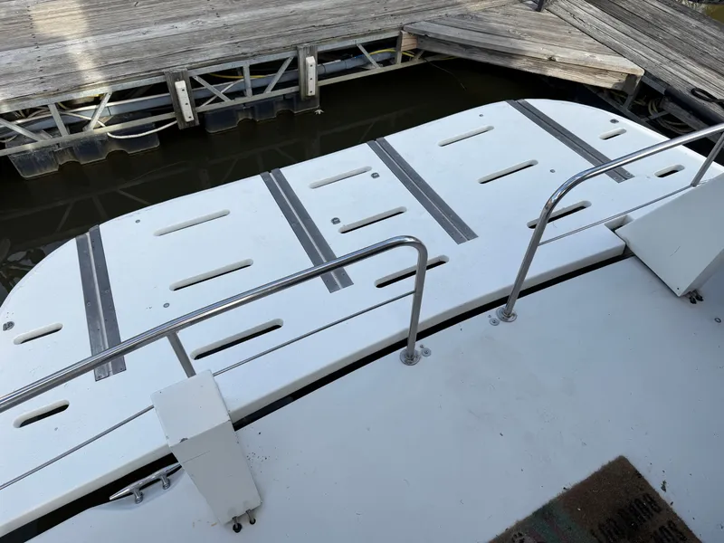 Slide: The Image of 1996 Bluewater Yachts 643 Motor Yacht swim platform with stainless steel railings at dock. - 26