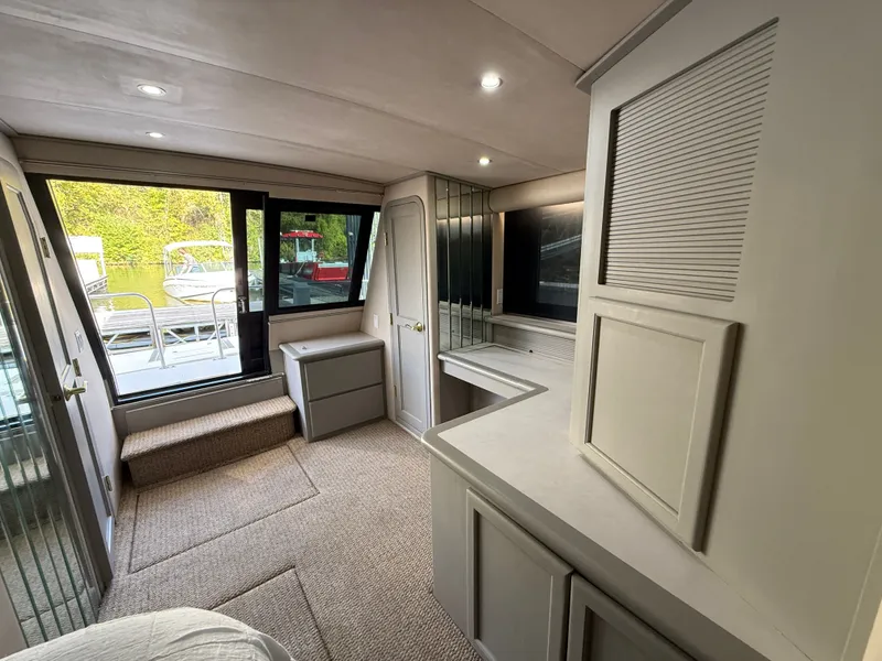 Slide: The Image of Interior of 1996 Bluewater Yachts 643 Motor Yacht with modern furnishings and large windows. - 28