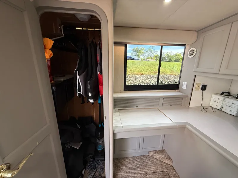 Slide: The Image of Interior of 1996 Bluewater Yachts 643 Motor Yacht with closet and window view. - 32