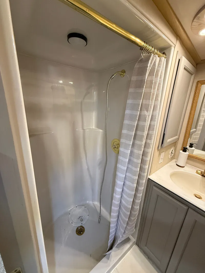Slide: The Image of Shower area in 1996 Bluewater Yachts 643 Motor Yacht with curtain and vanity. - 34