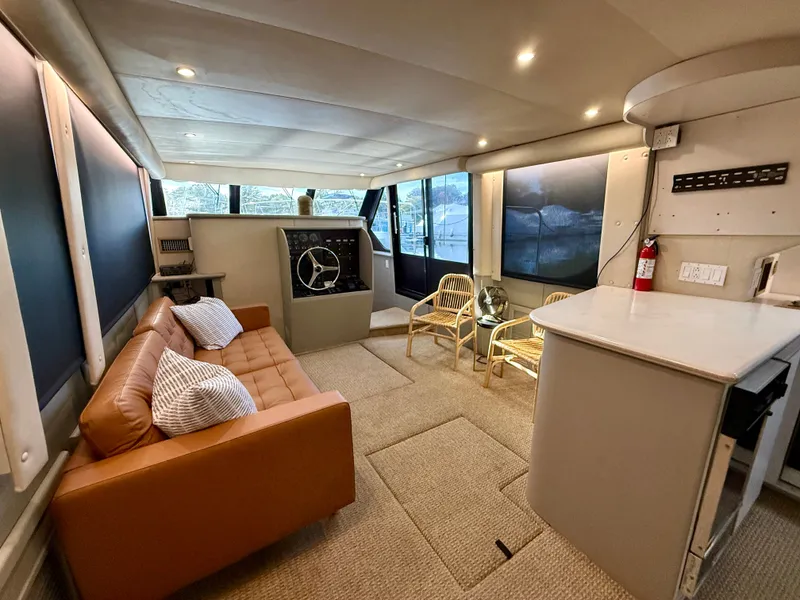 Slide: The Image of Luxurious interior of 1996 Bluewater Yachts 643 Motor Yacht with modern seating and helm. - 35