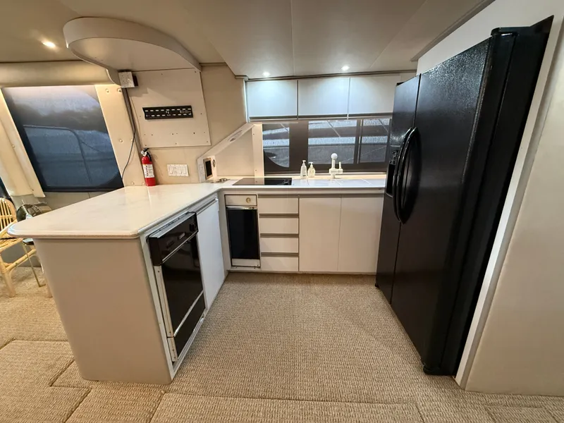 Slide: The Image of Modern kitchen interior of 1996 Bluewater Yachts 643 Motor Yacht with appliances and cabinetry. - 36