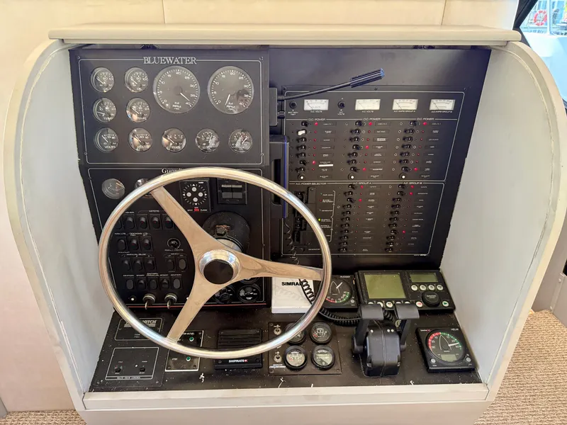 Slide: The Image of Control panel of a 1996 Bluewater Yachts 643 Motor Yacht with steering wheel and gauges. - 38