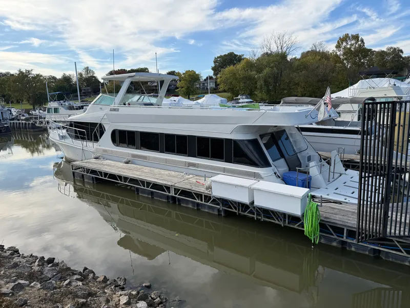 Slide: The Image of 1996 Bluewater Yachts 643 Motor Yacht docked in a serene marina setting. - 4