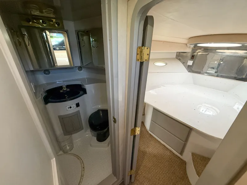 Slide: The Image of Interior of 1996 Bluewater Yachts 643 Motor Yacht, featuring bathroom and cabin area. - 42