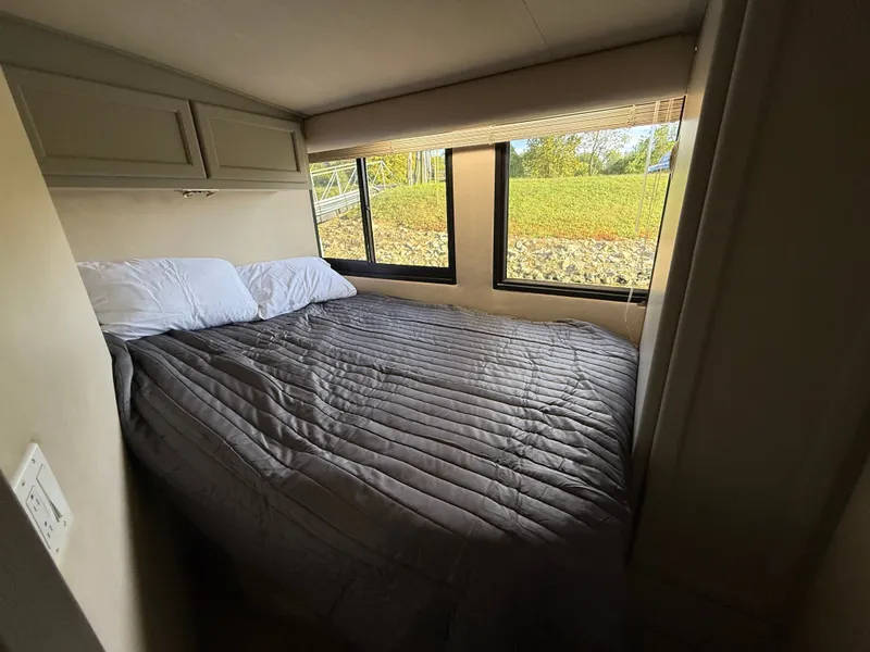 Slide: The Image of Cozy bedroom in 1996 Bluewater Yachts 643 Motor Yacht with large windows and gray bedding. - 45