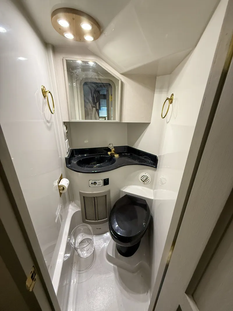 Slide: The Image of Compact bathroom in 1996 Bluewater Yachts 643 Motor Yacht, featuring modern fixtures and lighting. - 46