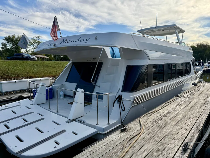 Slide: The Image of 1996 Bluewater Yachts 643 Motor Yacht docked, featuring sleek design and spacious deck. - 5