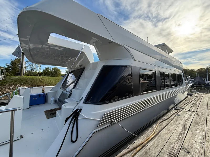 Slide: The Image of 1996 Bluewater Yachts 643 Motor Yacht docked under a partly cloudy sky. - 6