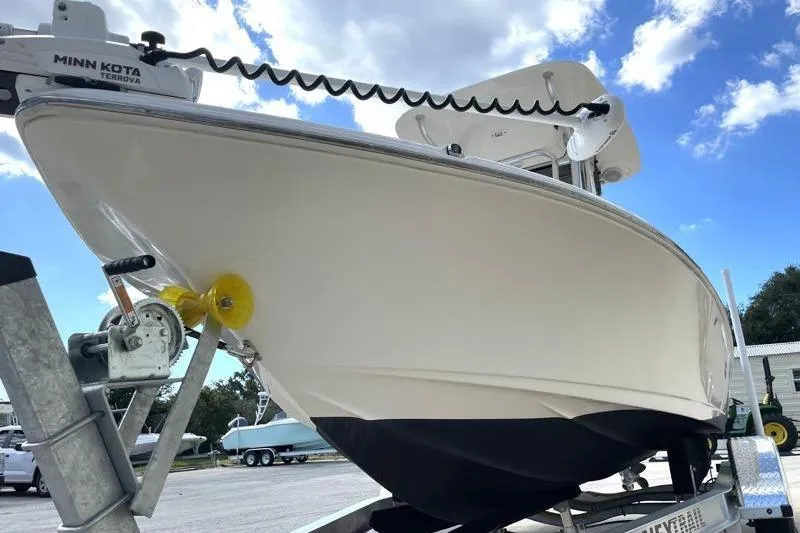 Slide: The Image of Minn Kota Terrova motor on 2024 Key West 210 Bay Reef boat under blue sky. - 10