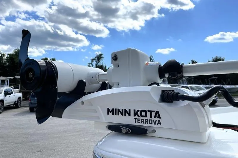 Slide: The Image of 2024 Key West 210 Bay Reef boat with trolling motor in a dealership lot. - 11