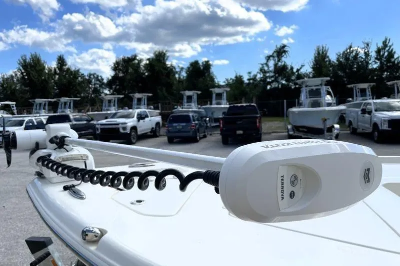 Slide: The Image of 2024 Key West 210 Bay Reef boat with Yamaha 150 engine, parked outdoors. - 12