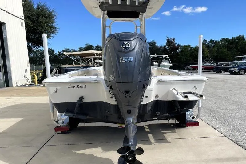 Slide: The Image of 2024 Key West 210 Bay Reef boat with Yamaha engine, parked outdoors. - 13
