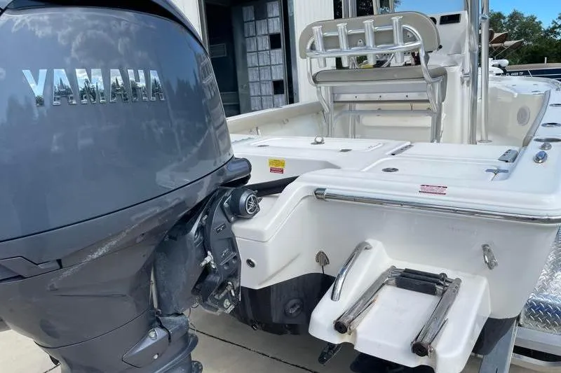 Slide: The Image of 2024 Key West 210 Bay Reef with Yamaha outboard motor in a marina setting. - 15