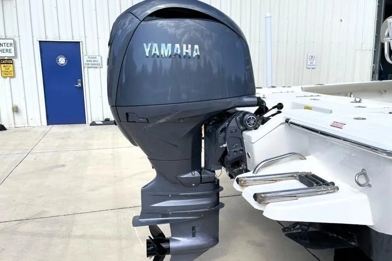 Slide: The Image of 2024 Key West 210 Bay Reef with Yamaha 150 outboard motor, docked outdoors. - 16