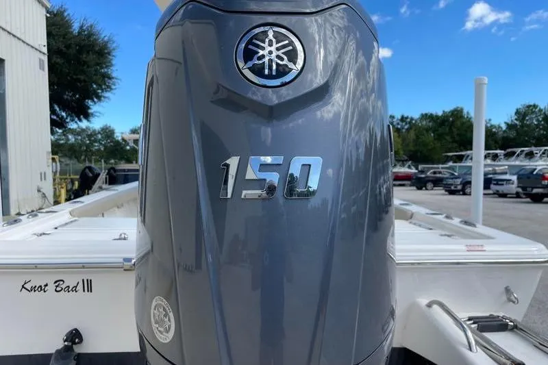 Slide: The Image of 2024 Key West 210 Bay Reef boat with T-top under a blue sky. - 17