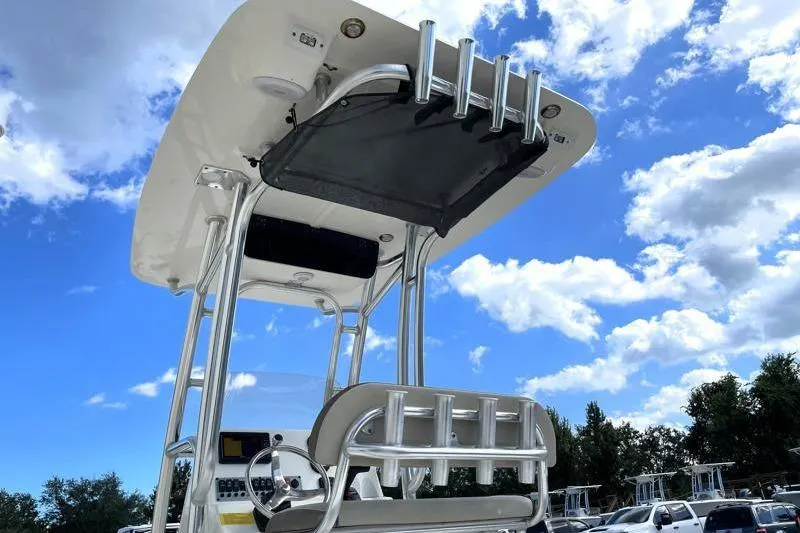 Slide: The Image of 2024 Key West 210 Bay Reef boat with T-top and seating, under a clear blue sky. - 18