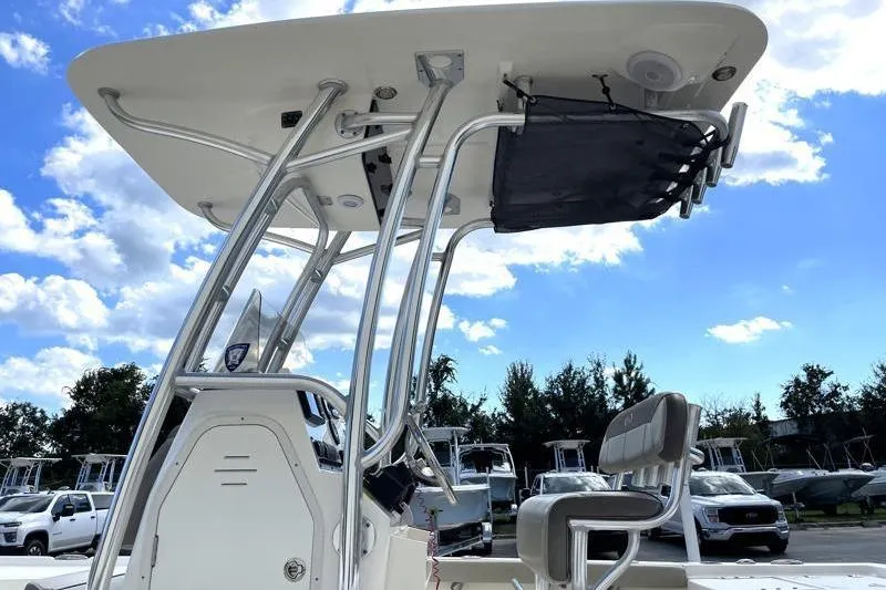 Slide: The Image of 2024 Key West 210 Bay Reef boat deck with trolling motor, showcasing spacious storage compartments. - 19