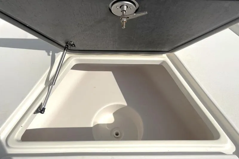 Slide: The Image of Livewell compartment on 2024 Key West 210 Bay Reef boat, open lid view. - 23