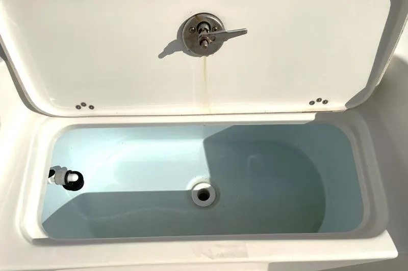 Slide: The Image of 2024 Key West 210 Bay Reef boat deck with storage compartment and hatch. - 24