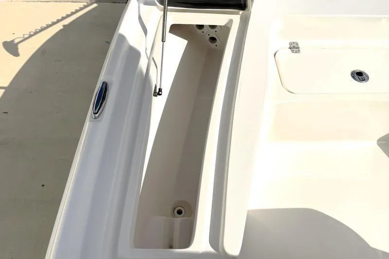 Slide: The Image of 2024 Key West 210 Bay Reef boat storage compartment, open lid, white interior. - 25