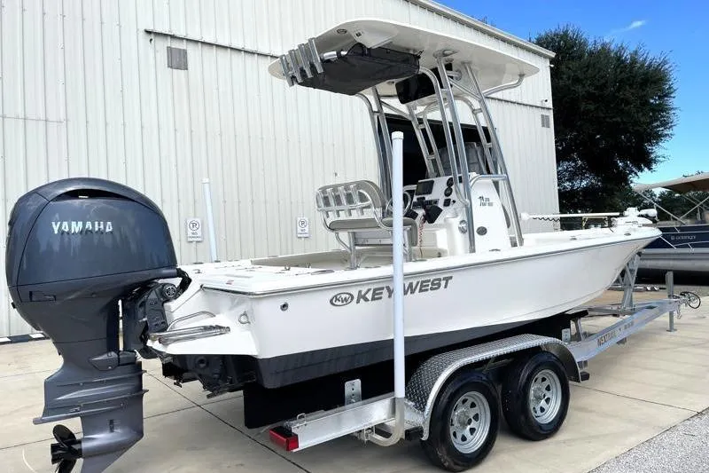 Slide: The Image of 2024 Key West 210 Bay Reef boat on trailer under blue sky. - 3