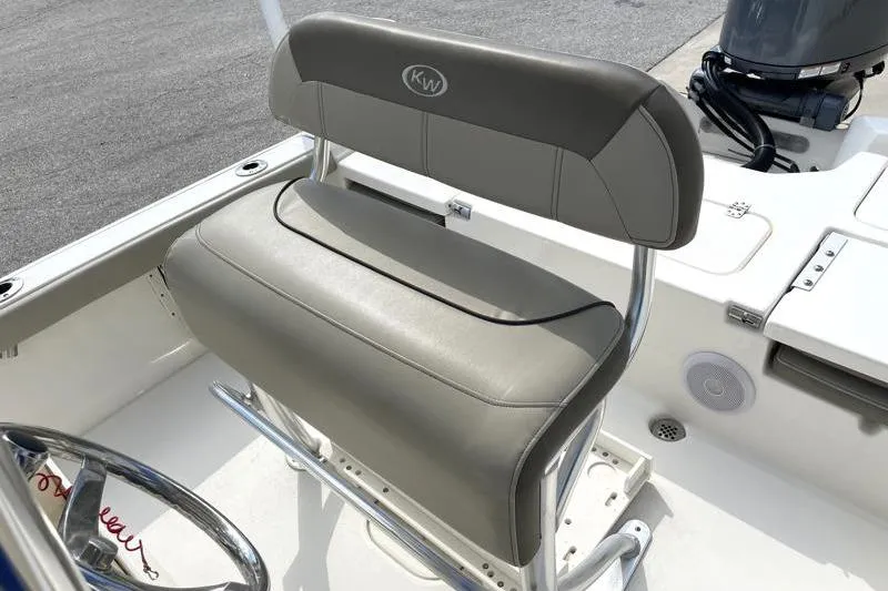 Slide: The Image of 2024 Key West 210 Bay Reef boat console with steering wheel and navigation controls. - 32