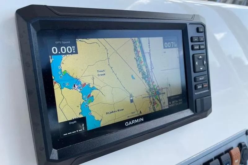 Slide: The Image of 2024 Key West 210 Bay Reef dashboard with Yamaha gauges and Fusion audio controls. - 34