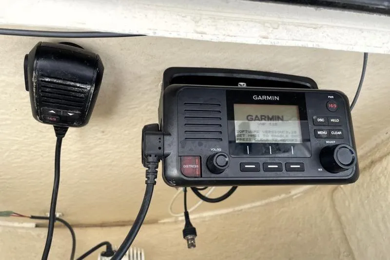 Slide: The Image of 2024 Key West 210 Bay Reef boat deck with storage compartments and motor. - 37