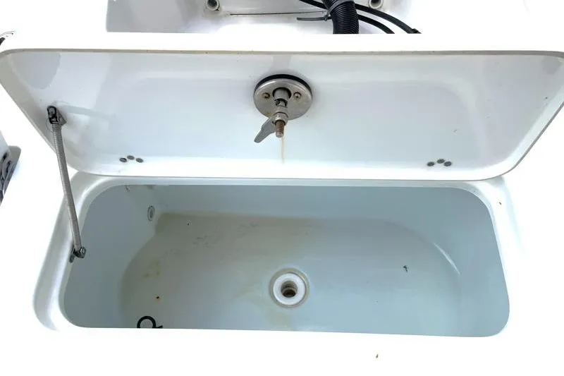 Slide: The Image of 2024 Key West 210 Bay Reef boat interior with rod holders and steering console. - 40