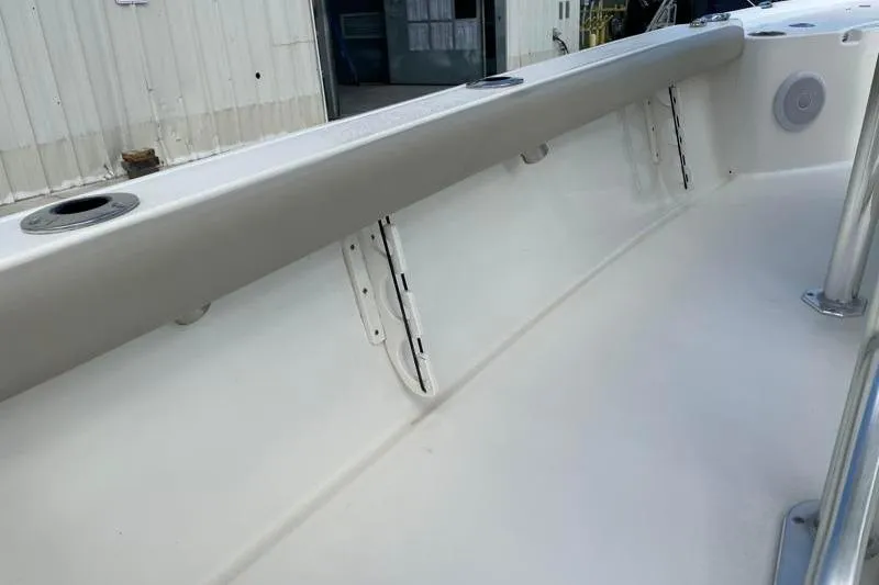 Slide: The Image of 2024 Key West 210 Bay Reef boat interior with rod holders and cup holders. - 43