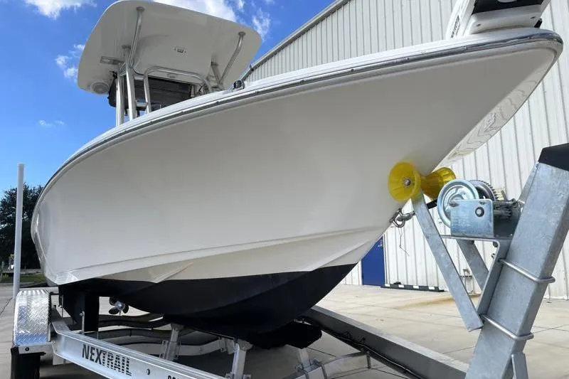 Slide: The Image of 2024 Key West 210 Bay Reef boat on trailer under blue sky. - 9