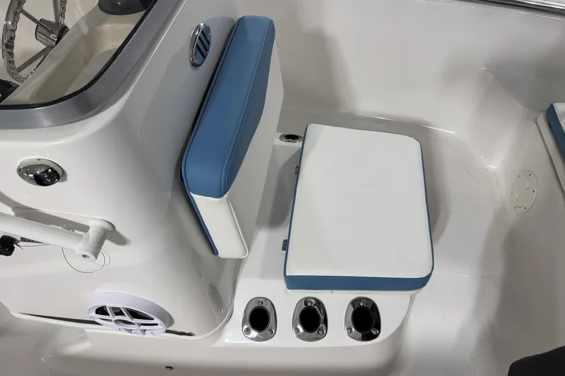 Slide: The Image of 2026 Robalo R160 Center Console boat interior with blue and white seating and console details. - 9