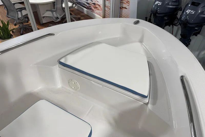 Slide: The Image of 2026 Robalo R160 Center Console boat interior with cushioned seating and dual Yamaha 25 engines. - 11