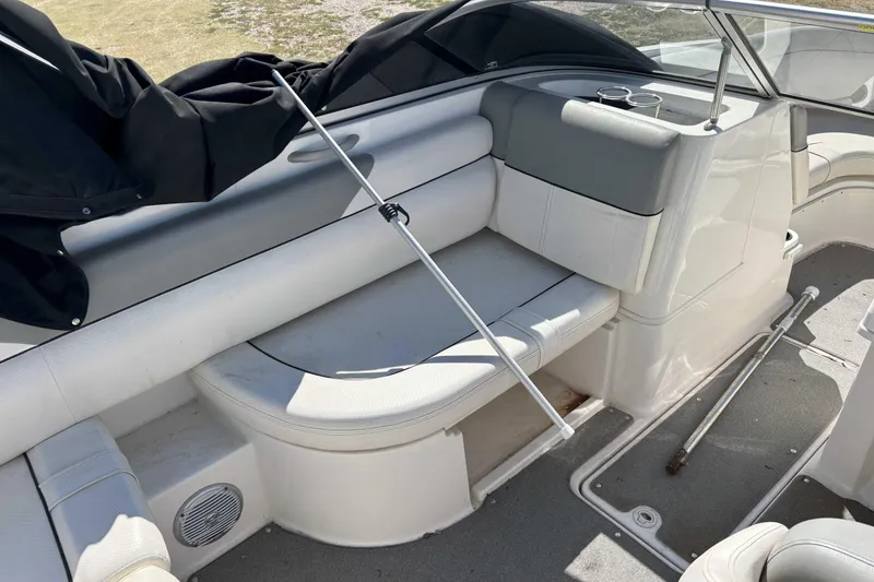 Slide: The Image of 2013 Bayliner 190 Deck Boat interior with white seating and cup holders. - 5
