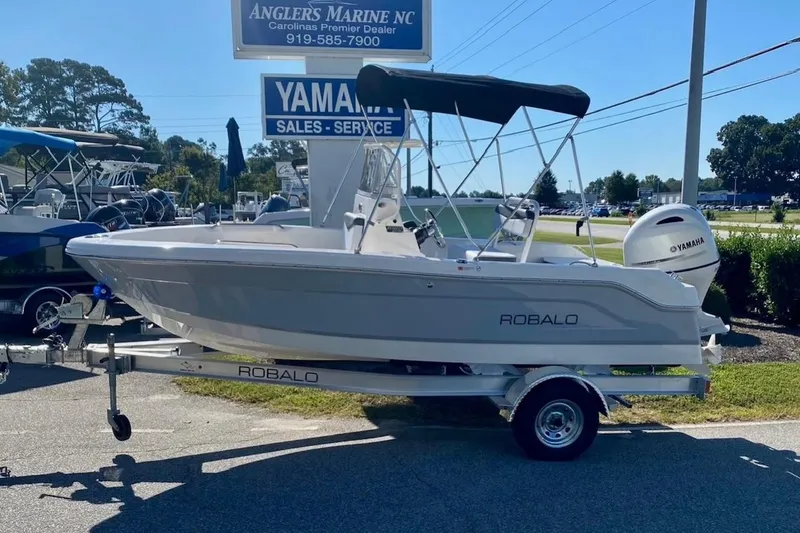 Slide: The Image of 2026 Robalo R160 Center Console boat on trailer at dealership. - 4