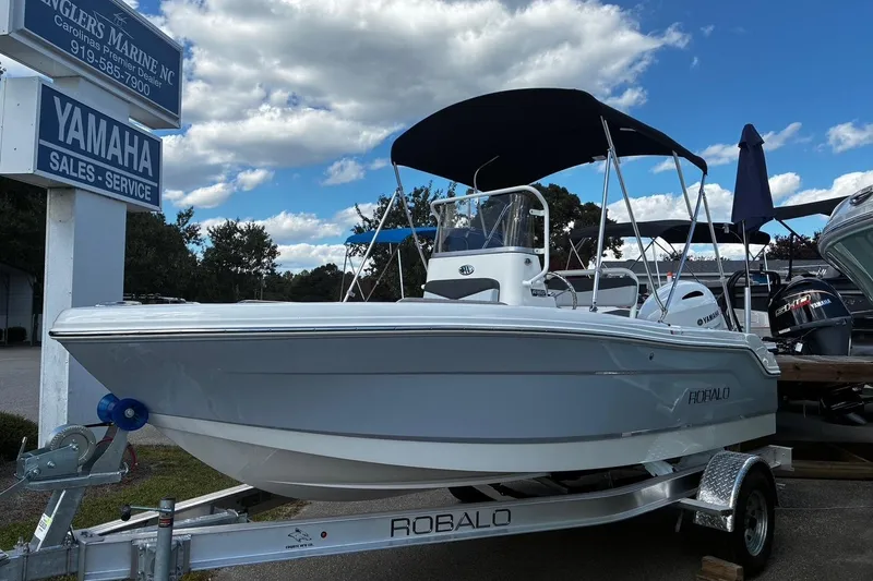 The Image of 2026 Robalo R160 Center Console boat on trailer at Yamaha dealership. - 1